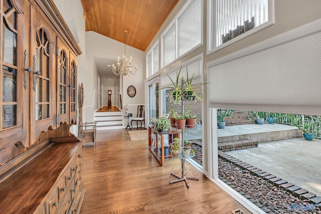 411 Darby Ave, Sheffield, AL 35660 - corridor featuring stairway, high vaulted ceiling, wood ceiling, a notable chandelier, and wood finished floors