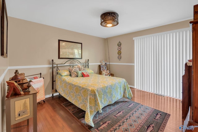 411 Darby Ave, Sheffield, AL 35660 - bedroom with baseboards and dark wood finished floors