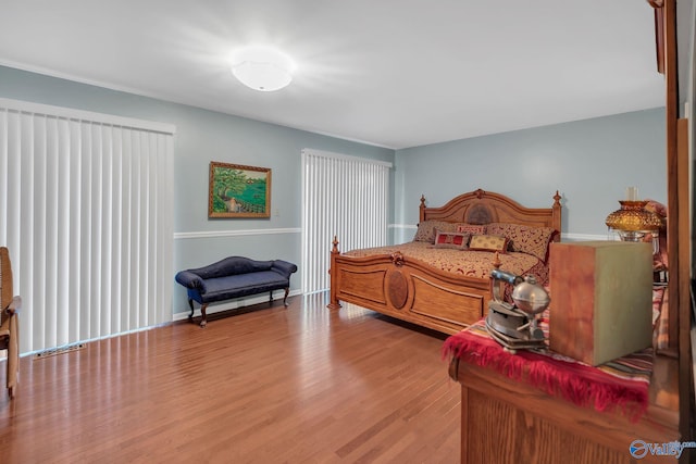 411 Darby Ave, Sheffield, AL 35660 - bedroom with baseboards and wood finished floors