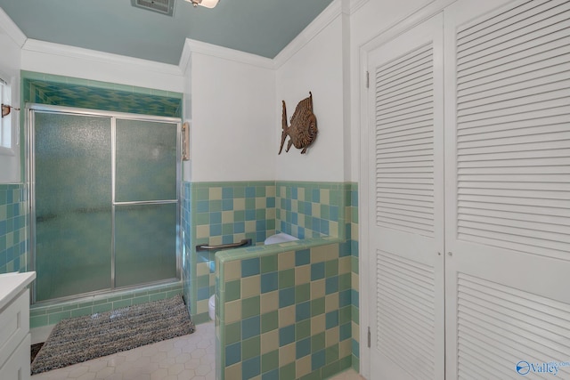 411 Darby Ave, Sheffield, AL 35660 - full bath featuring crown molding, a closet, tile walls, and a shower stall