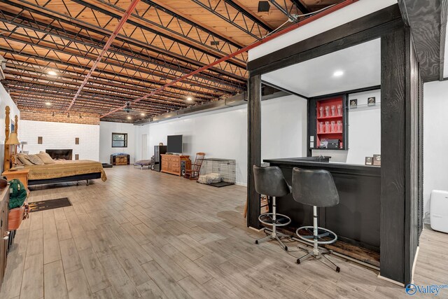 411 Darby Ave, Sheffield, AL 35660 - finished below grade area featuring wood finished floors, bar, and brick wall
