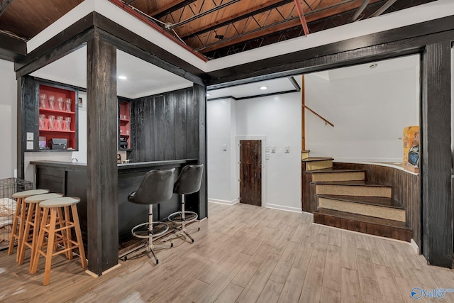 411 Darby Ave, Sheffield, AL 35660 - bar featuring stairs, wood finished floors, indoor wet bar, and baseboards