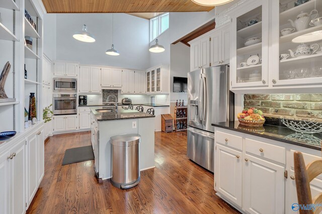 411 Darby Ave, Sheffield, AL 35660 - kitchen with dark wood finished floors, white cabinetry, a sink, and stainless steel appliances