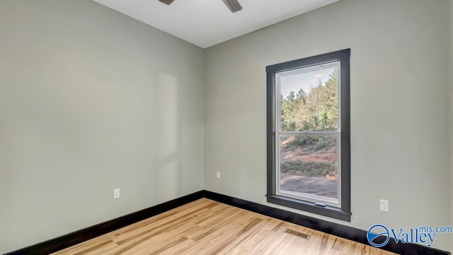 empty room with hardwood / wood-style flooring and ceiling fan