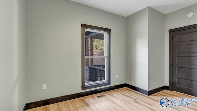 empty room with light hardwood / wood-style flooring