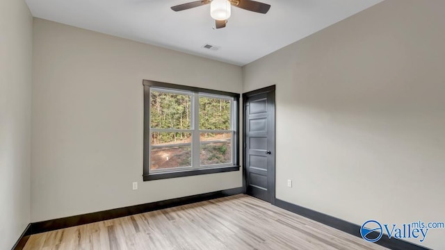 empty room featuring light hardwood / wood-style flooring and ceiling fan