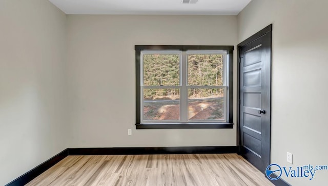 spare room featuring light hardwood / wood-style floors