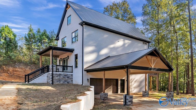 exterior space with a porch and a garage