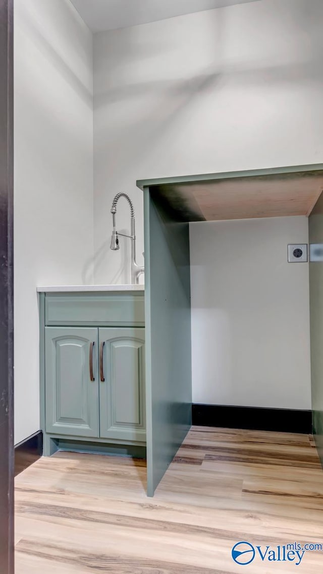 bathroom with hardwood / wood-style flooring and sink