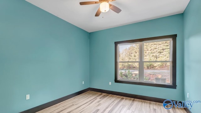 spare room featuring light wood-type flooring and ceiling fan