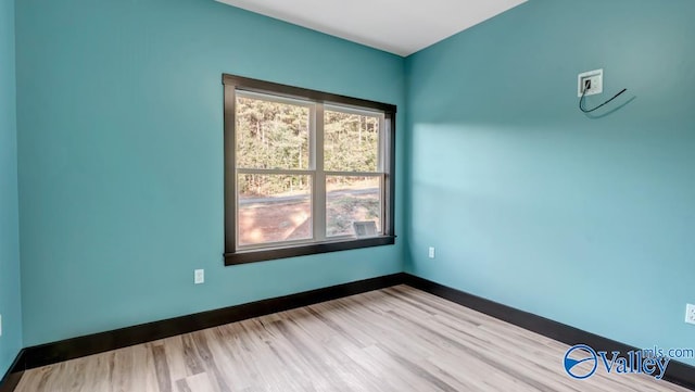 spare room featuring light wood-type flooring