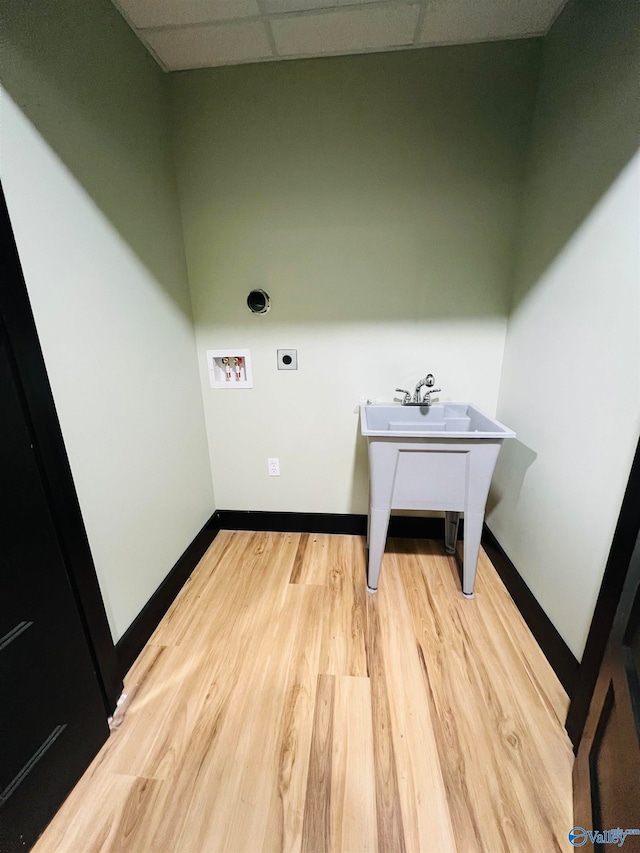 laundry room with electric dryer hookup, hookup for a washing machine, and light hardwood / wood-style floors