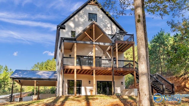 rear view of property featuring a wooden deck