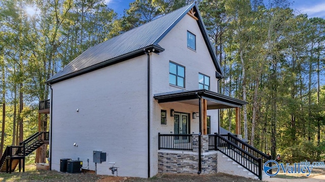 view of property exterior featuring a porch and cooling unit