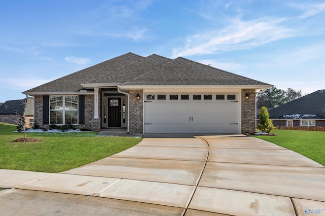 view of front of house with driveway, a shingled roof, an attached garage, a front yard, and brick siding