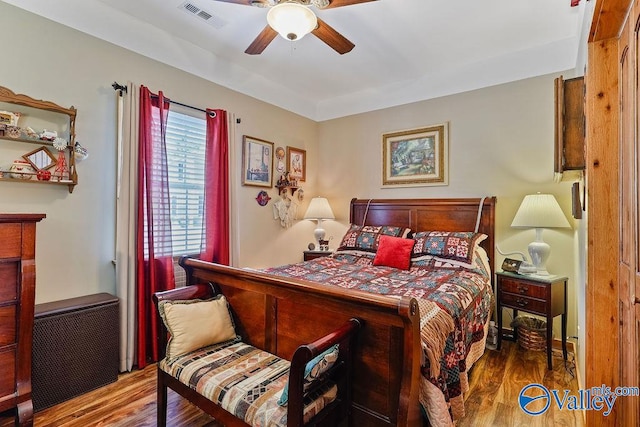 bedroom featuring ceiling fan, hardwood / wood-style flooring, and radiator