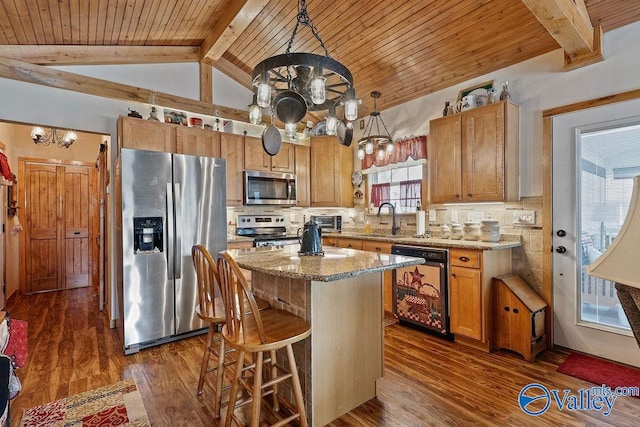 kitchen with tasteful backsplash, dark hardwood / wood-style flooring, a kitchen island, sink, and appliances with stainless steel finishes