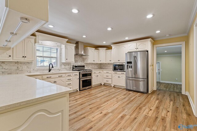 kitchen featuring light hardwood / wood-style flooring, backsplash, wall chimney exhaust hood, ornamental molding, and high end appliances