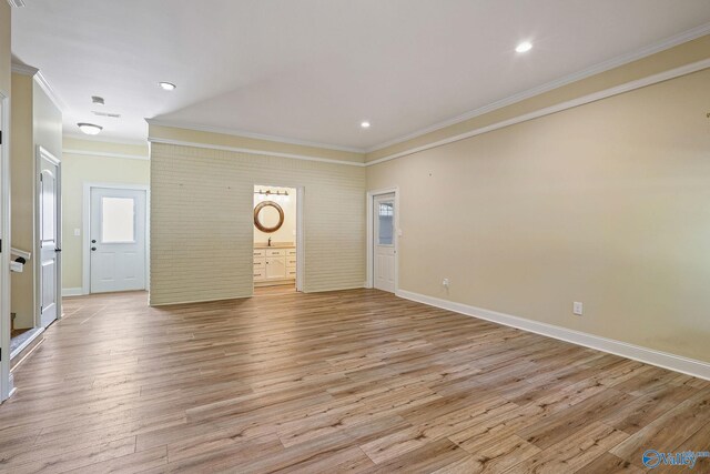 interior space featuring sink, crown molding, and light wood-type flooring