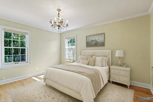 bedroom featuring light wood-type flooring, an inviting chandelier, and crown molding