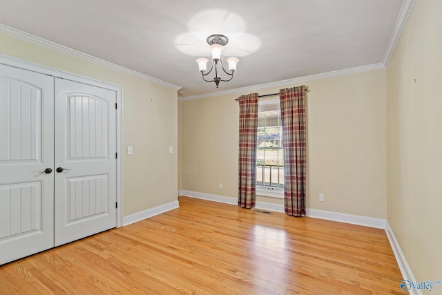 unfurnished bedroom featuring light wood-type flooring, a closet, a notable chandelier, and ornamental molding