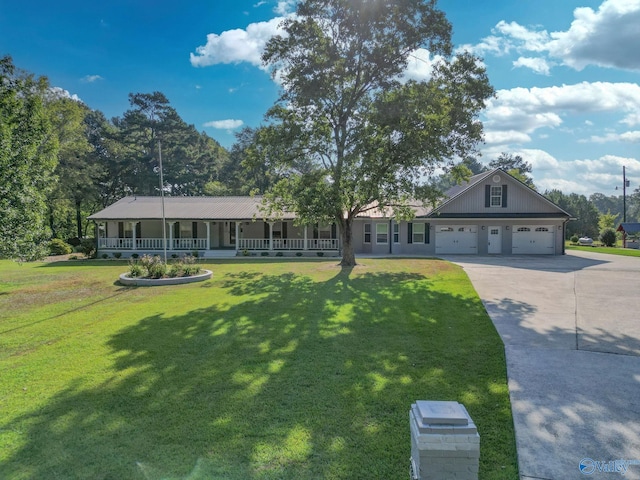 view of front facade with a porch, a front yard, and a garage