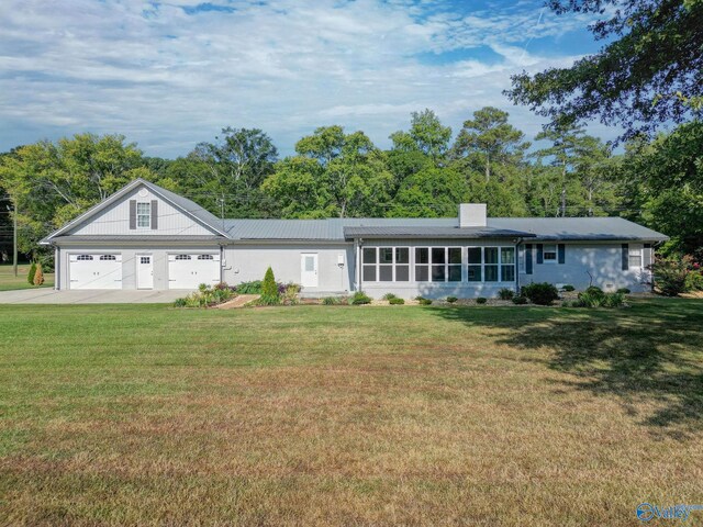 ranch-style home featuring a garage and a front yard