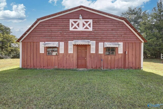 view of outdoor structure featuring a lawn