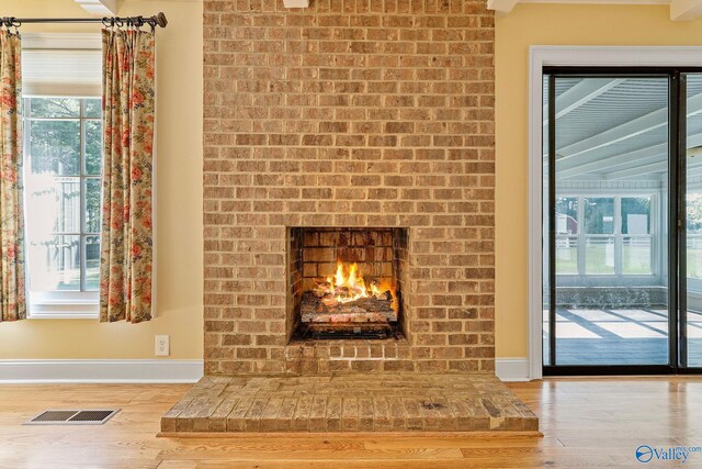 room details featuring hardwood / wood-style flooring and a brick fireplace