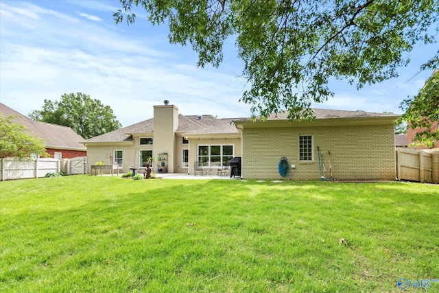 2613 Elderdale Dr, Owens Cross Roads, AL 35763 - rear view of house with a patio, brick siding, a chimney, and a gate
