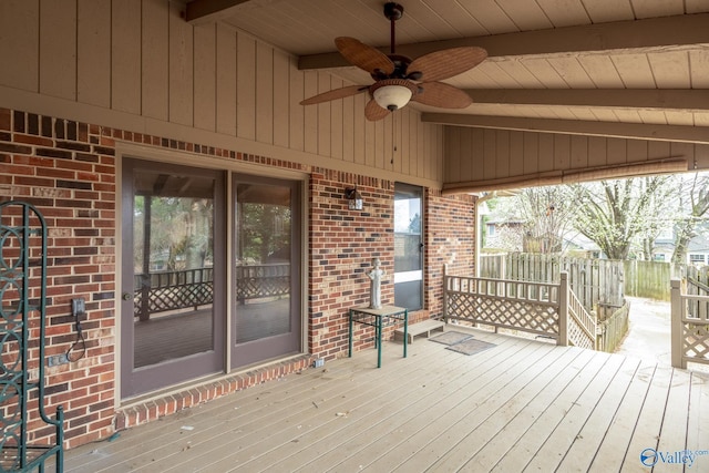 wooden terrace featuring a ceiling fan and fence