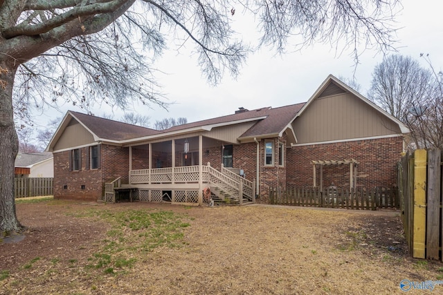 view of front facade with fence, a porch, a chimney, crawl space, and brick siding