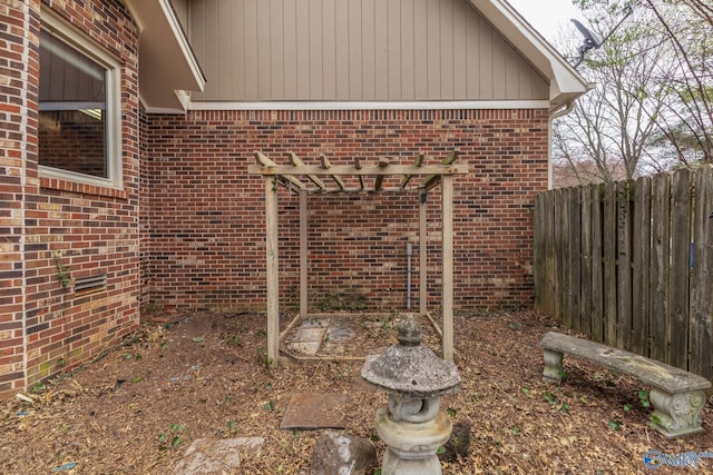 exterior space featuring brick siding and fence