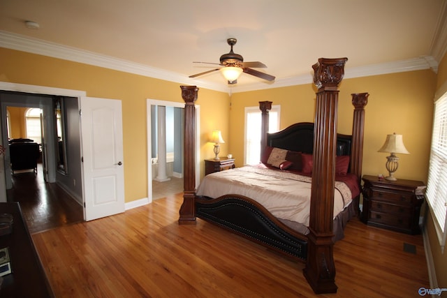 bedroom with crown molding, hardwood / wood-style floors, ceiling fan, and ensuite bath