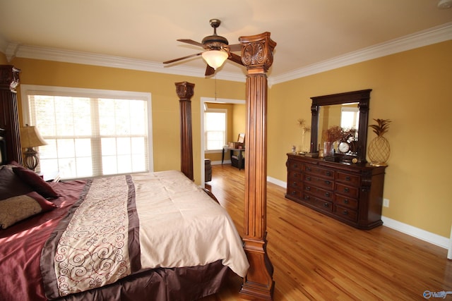 bedroom featuring crown molding, light hardwood / wood-style floors, and ceiling fan