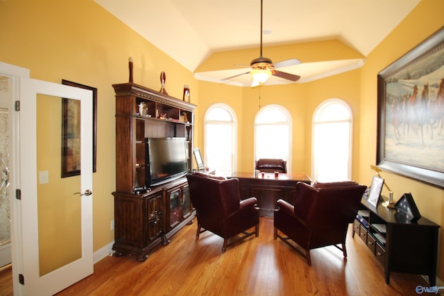 home office with ceiling fan, plenty of natural light, vaulted ceiling, and light wood-type flooring