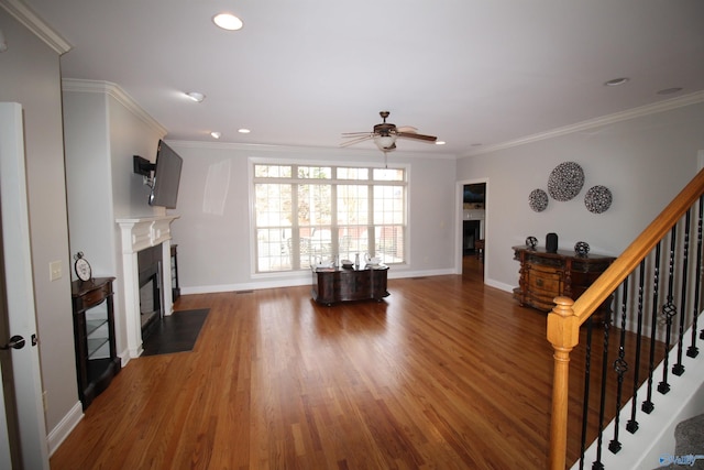 living room with crown molding, ceiling fan, and dark hardwood / wood-style flooring