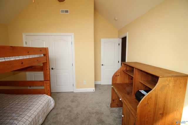 bedroom with vaulted ceiling and light colored carpet