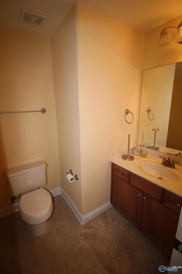 bathroom featuring vanity, toilet, and tile patterned flooring