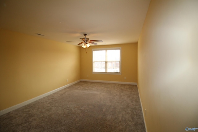 empty room with ceiling fan and carpet flooring