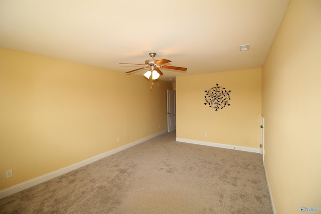 unfurnished room featuring ceiling fan and carpet