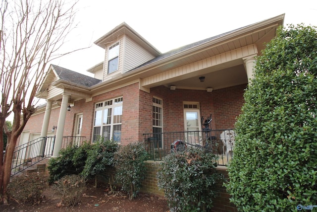 view of side of property with a porch