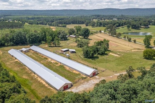 birds eye view of property featuring a water and mountain view and a rural view