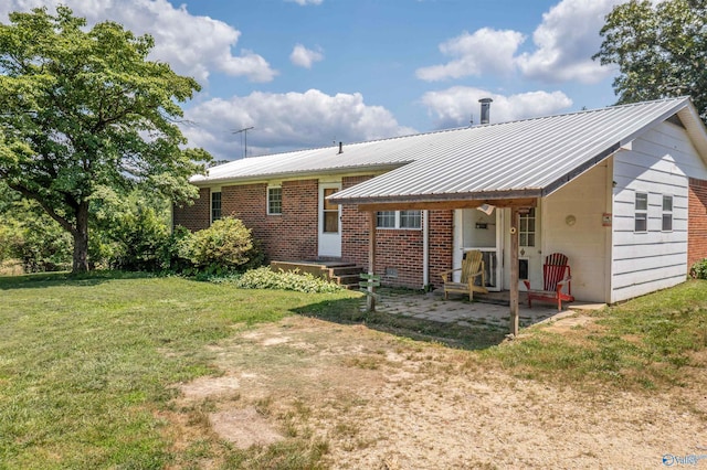 rear view of house with a lawn