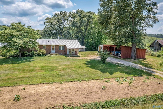 ranch-style home featuring an outbuilding and a front lawn