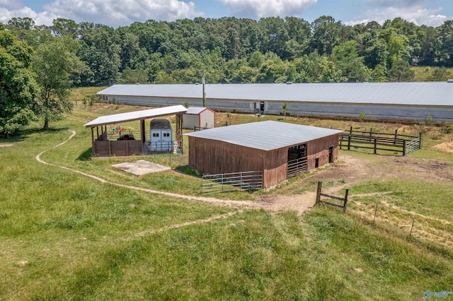 view of horse barn with a rural view