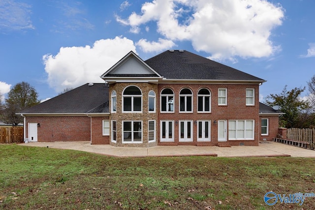 rear view of property with a yard and a patio