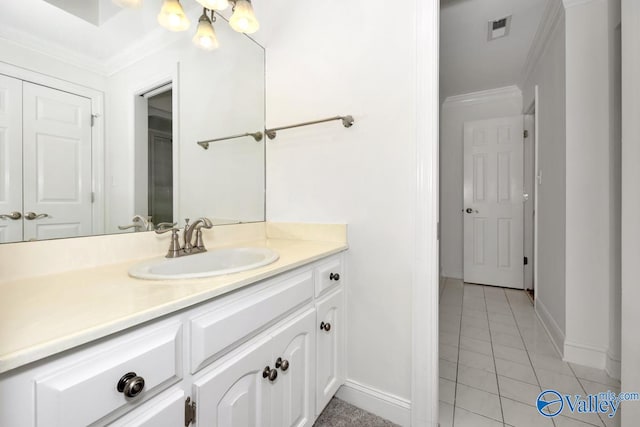 bathroom featuring vanity, tile patterned floors, and crown molding