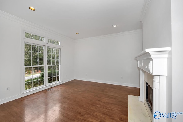 unfurnished living room with dark hardwood / wood-style flooring and ornamental molding