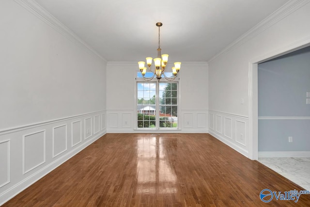 unfurnished dining area featuring an inviting chandelier, wood-type flooring, and ornamental molding